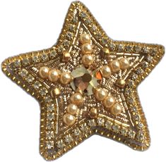 a gold star brooch with pearls on it