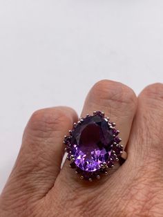 This is a vintage purple amethyst with pink tourmaline  sidestones set in 925 sterling We have in size 6 this can be sized to your specification, our jeweler charges $20 please message us to discuss sizing your ring or engraving options. All of our jewelry is hand polished and shipped to you in a stylish gift box.  We are happy to gift wrap for you.  It is important to us that each customer be thrilled with their purchase.  We are grateful for thousands of positive reviews.  PLEASE NOTE If we ha Formal Purple Multi-stone Amethyst Ring, Formal Purple Sterling Silver Ring, Formal Purple Sapphire Ring In Sterling Silver, Collectible Purple Amethyst Ring With Center Stone, Classic Purple Ruby Ring, Formal Purple Ruby Ring With Center Stone, Formal Purple Oval Ruby Ring, Formal Purple Ruby Ring, Classic Multi-stone Purple Amethyst Ring