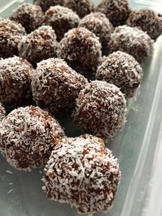 there are many chocolate balls in the plastic container