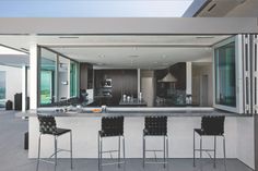 an image of a modern kitchen with bar stools