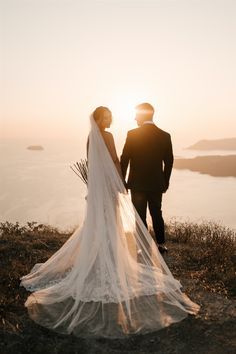 wedding photoshoot Greece Wedding Photoshoot, Wedding Photo Sunset, Romantic Wedding Photos Aesthetic, Santorini Wedding Photography, Wedding Photo Ideas Bride And Groom Outdoor, Sitting Wedding Poses, Landscape Wedding Photography, Bride And Groom Beach Wedding Photos, Wedding Sunset Photos