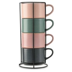 four cups are stacked on each other in a metal holder, with different colors and shapes