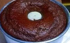 a chocolate cake in a blue tin on a table