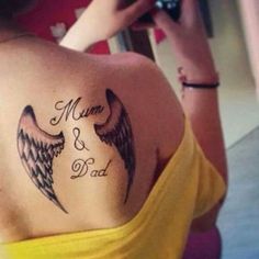 the back of a woman's shoulder with an angel tattoo