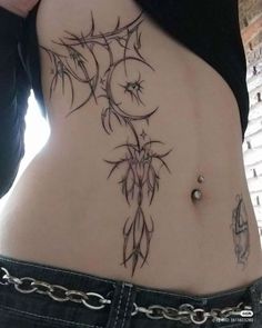 a woman's stomach with tattoos on it