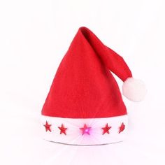 a red and white santa hat with stars on the side, sitting up against a white background