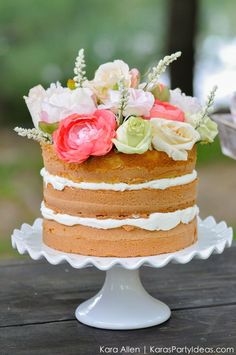 a multi layer cake with flowers on top