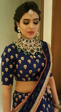 a woman in a blue lehenga with gold jewelry