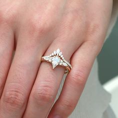 a woman's hand with a diamond ring on top of her finger and an engagement band