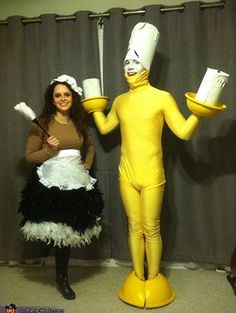 two women dressed in costumes standing next to each other with mugs on their hands