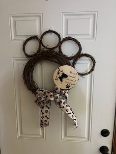 a dog's paw is attached to the front door with a wreath on it