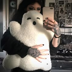 a woman holding a white teddy bear in her arms