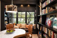 a room filled with lots of books and furniture