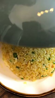 a white plate topped with rice and vegetables