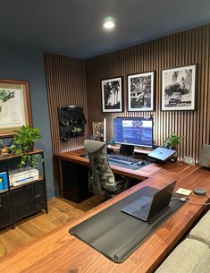 a desk with a laptop computer on top of it next to a chair and other office supplies