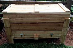 a wooden box sitting in the grass