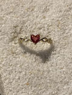 Adorn your finger with the timeless allure of this ruby red heart ring.  Crafted with a shimmering gold-plated band, this size 6 ring whispers elegance and makes a cherished gift for any occasion. Perfect for everyday wear, it adds a touch of romantic charm to any outfit. Red Heart Ring, Ruby Heart Ring, Cute Promise Rings, Ruby Heart, Edgy Jewelry, Gold Promise Rings, Jewelry Accessories Ideas, Classy Jewelry, Jewelry Lookbook