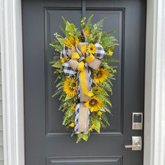 a sunflower wreath is hanging on the front door