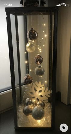 a display case with ornaments and lights in it