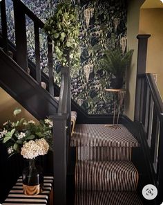 the stairs are decorated with plants and striped rugs