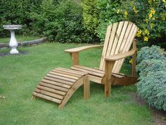 a wooden chair and foot rest in the grass