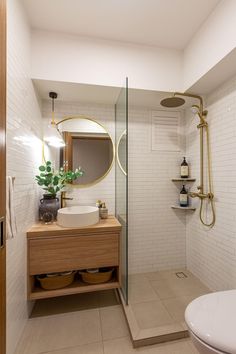 a bathroom with a toilet, sink and shower stall in the corner next to a bathtub