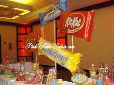 a table with candy bar flags and candies on it at a banquet or party