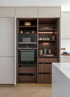 a kitchen with an oven and cabinets in it