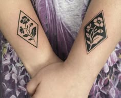 two tattoos on the arms of people with flowers and diamond shapes in front of them