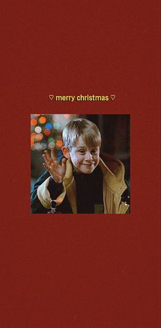 a red christmas card with a photo of a boy holding his hand up in the air