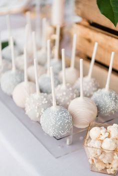 there are many different types of candies on the table with white and silver sprinkles