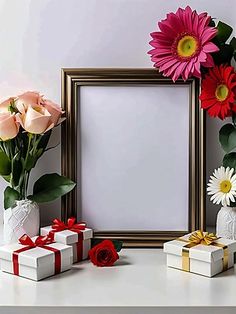 there are flowers in vases and gift boxes next to the picture frame on the table