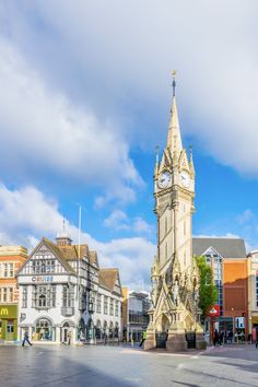 a large clock tower sitting in the middle of a town