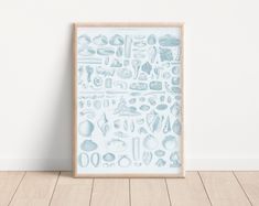 an art print with sea life on it in a wooden frame against a white wall