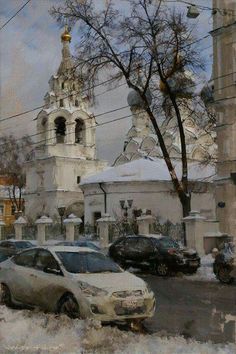 two cars parked in front of a church on a city street with snow covered ground