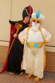 two people dressed in costumes standing next to each other