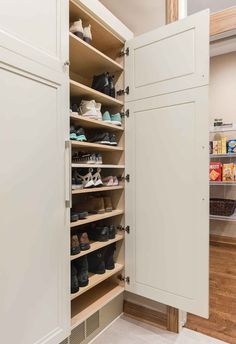 an organized closet with shoes and other items in the corner, including shelves that hold several pairs of shoes