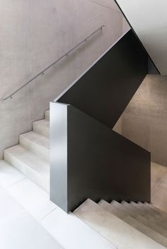 the stairs are made of steel and have black metal handrails