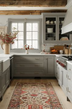 a kitchen with gray cabinets and an area rug