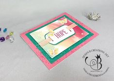 a close up of a card on a table with some beads and a tiara