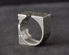 "Chunky Ring For Men - Handmade In Sterling Silver - Industrial, Raw And Rustic ◆ DIMENSIONS ◆ Ring width: 10mm // 0,39\" ◆ MATERIAL & TECHNIQUE ◆ Solid 925 sterling silver cast in sand. This industrial ring is part of our \"EMBRACING CHAOS\" collection, a tribute to life itself. The unexpected is around every corner, and about to happen... It is our aim to embrace this chaos and the imperfections in it, and our jewelry is a representation of it. Because each ring is cast in sand individuall Brutalist Oxidized Finish Ring For Gift, Luxury Brutalist Metal Rings, Industrial Ring, Brutalist Silver Hand Cast Rings, Silver Brutalist Hammered Ring, Silver Brutalist Hand-cast Rings, Stamp Maker, Architectural Jewelry, Chunky Rings