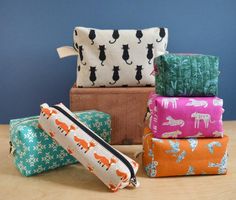 four different types of bags sitting on top of a wooden table next to each other