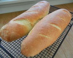 two loaves of bread sitting on a cooling rack