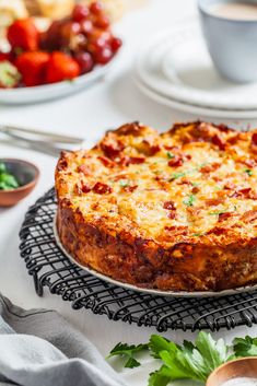 a pizza sitting on top of a table next to other plates and utensils