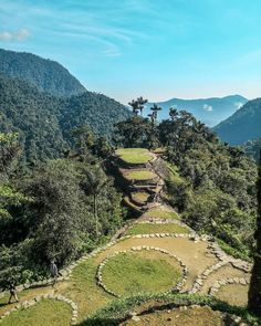 an aerial view of the ancient ruins in the jungle with trees and mountains behind it