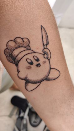 a person with a tattoo on their arm holding a knife