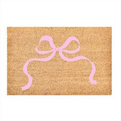 a door mat with a pink ribbon on it