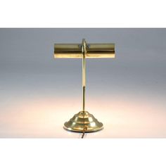 a brass table lamp with a white background