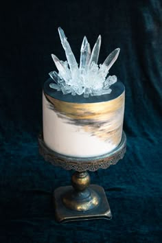 a white cake with frosting and crystal decorations