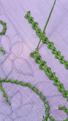 the green thread has been stitched together to make a cross - stitch pattern on the fabric